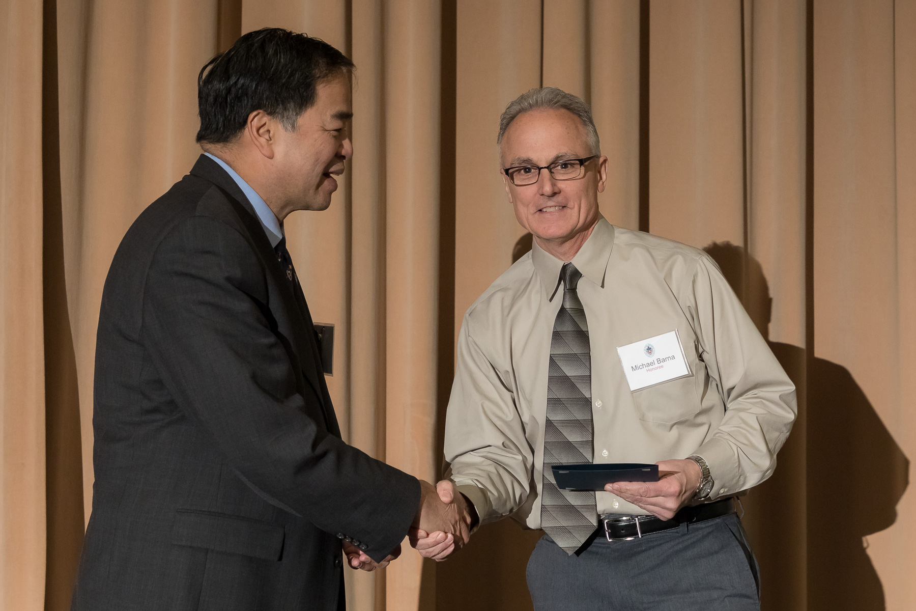 Michael Barna, right, with A. Gabriel Esteban, Ph.D., president, as faculty and staff members are inducted into DePaul University's 25 Year Club, Tuesday, Nov. 13, 2018, at the Lincoln Park Student Center. Employees celebrating their 25th work anniversary were honored at the luncheon with their colleagues and will have their names added to plaques located on the Loop and Lincoln Park Campuses. (DePaul University/Jeff Carrion)